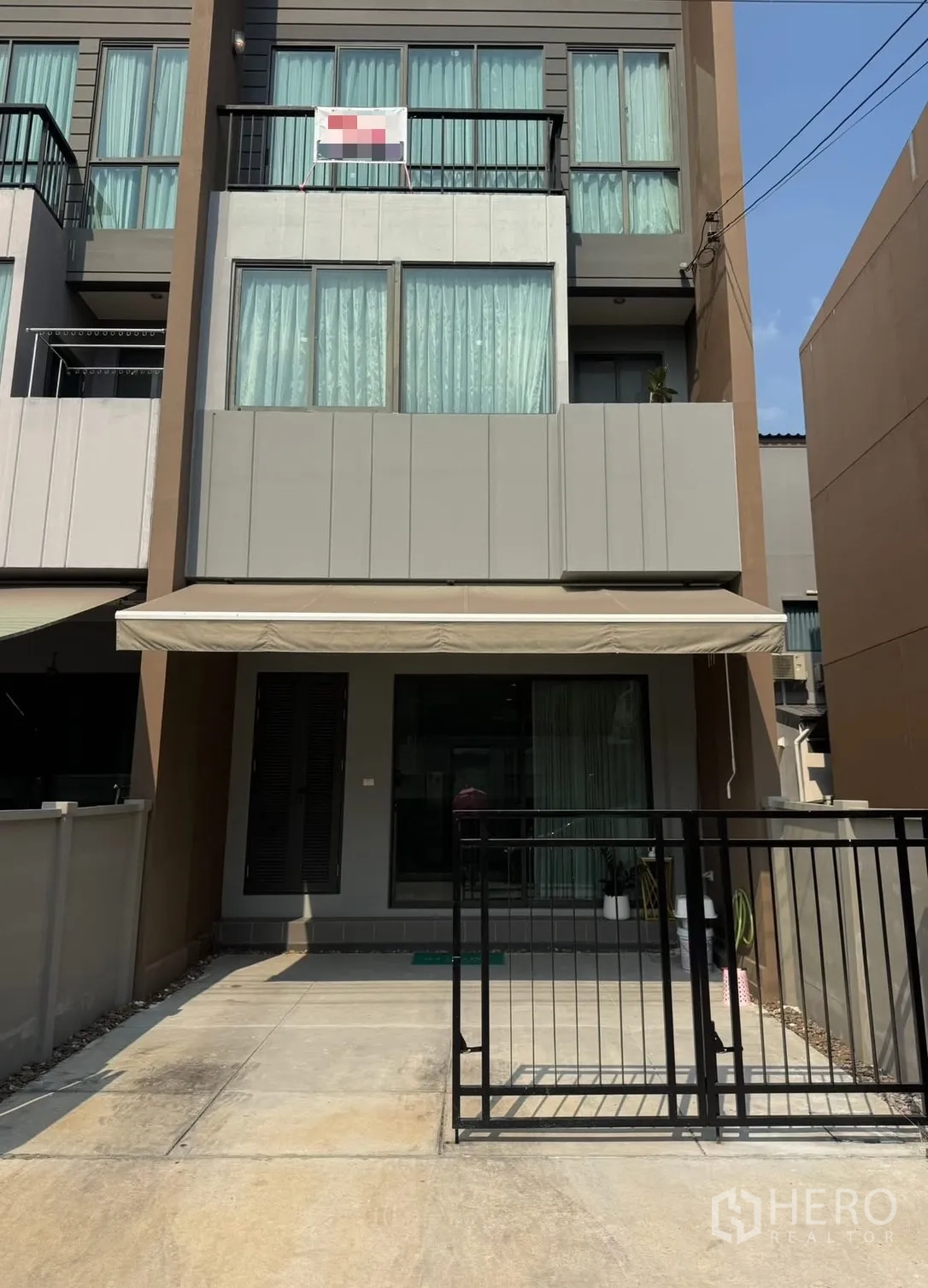 Townhouse for rent in Saphan Sung, Bangkok - Modern three-storey townhouse exterior with balcony, wide windows and front gate in Saphan Sung.