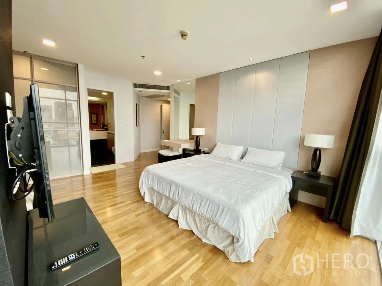 Condominium for rent or sale in Sathon, Bangkok - Large master bedroom with king bed, TV console, and ensuite access.