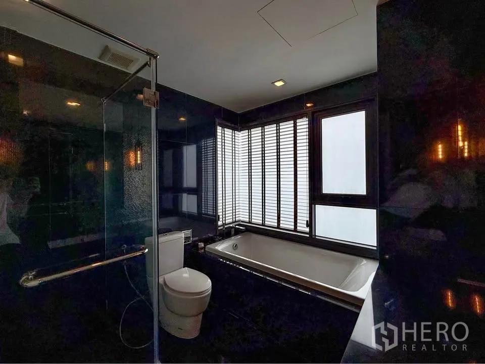 公寓 for rent in Khlong Toei, Bangkok - 浴室设独立淋浴与靠窗浴缸，配百叶窗。