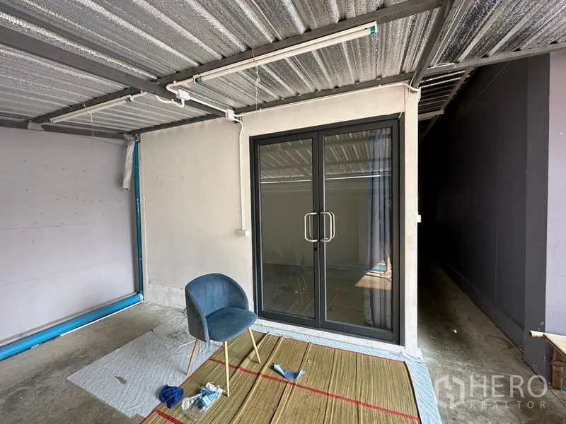 工厂 出租或出售在Lam Luk Ka, Pathum Thani - 金属顶棚下的侧边区域，带推拉玻璃门。