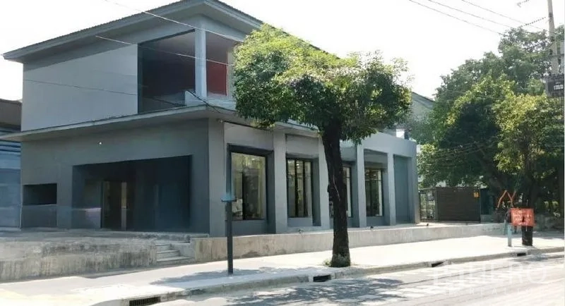 Retail Space for rent in Khlong Toei, Bangkok - Modern two-storey retail building with large glass storefronts and wide pavement in Khlong Toei, Bangkok.