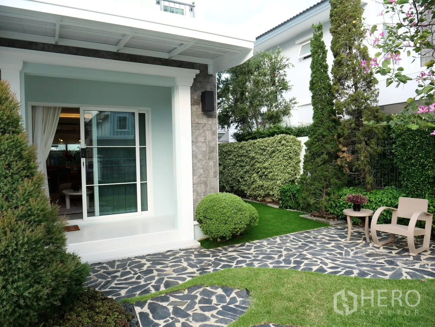 Detached House for rent in Bang Phli, Samut Prakan - Sliding glass door opening to a garden patio with hedges.