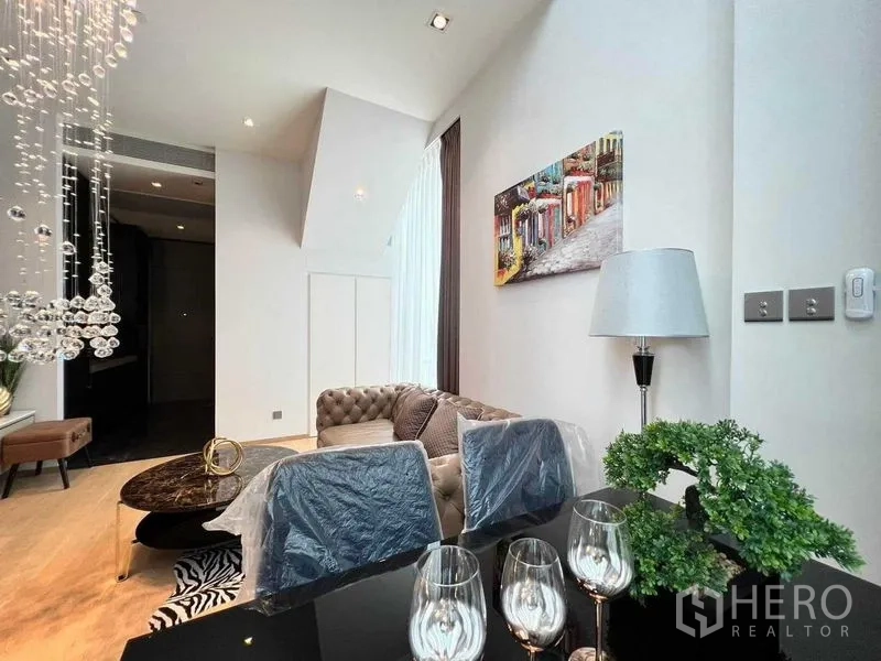 Condominium for rent - Dining nook with glass table, upholstered chairs and tall curtains beside the lounge.