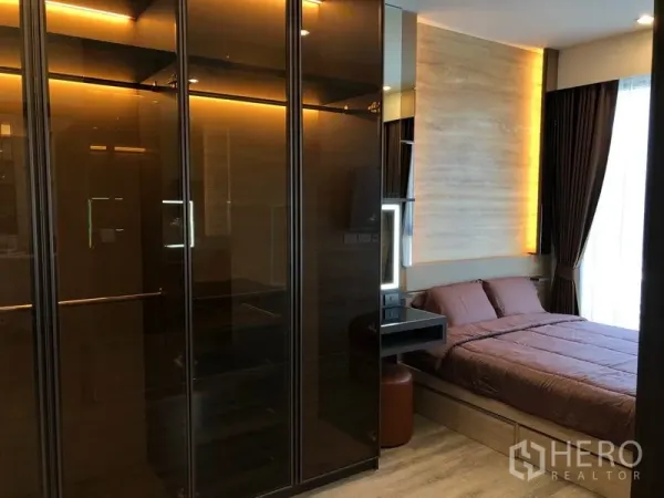 Condominium for rent in Bang Na, Bangkok - Bedroom featuring ambient lighting, glass wardrobes and a bed next to the window.