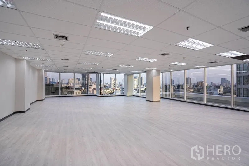 Office Space for rent in Sathon, Bangkok - Bright open office space with large windows and grid ceiling lights.