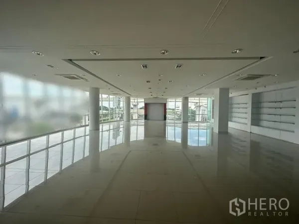 Office Space for rent in Prawet, Bangkok - Open showroom-style floor with expansive windows, recessed lighting and tiled flooring.