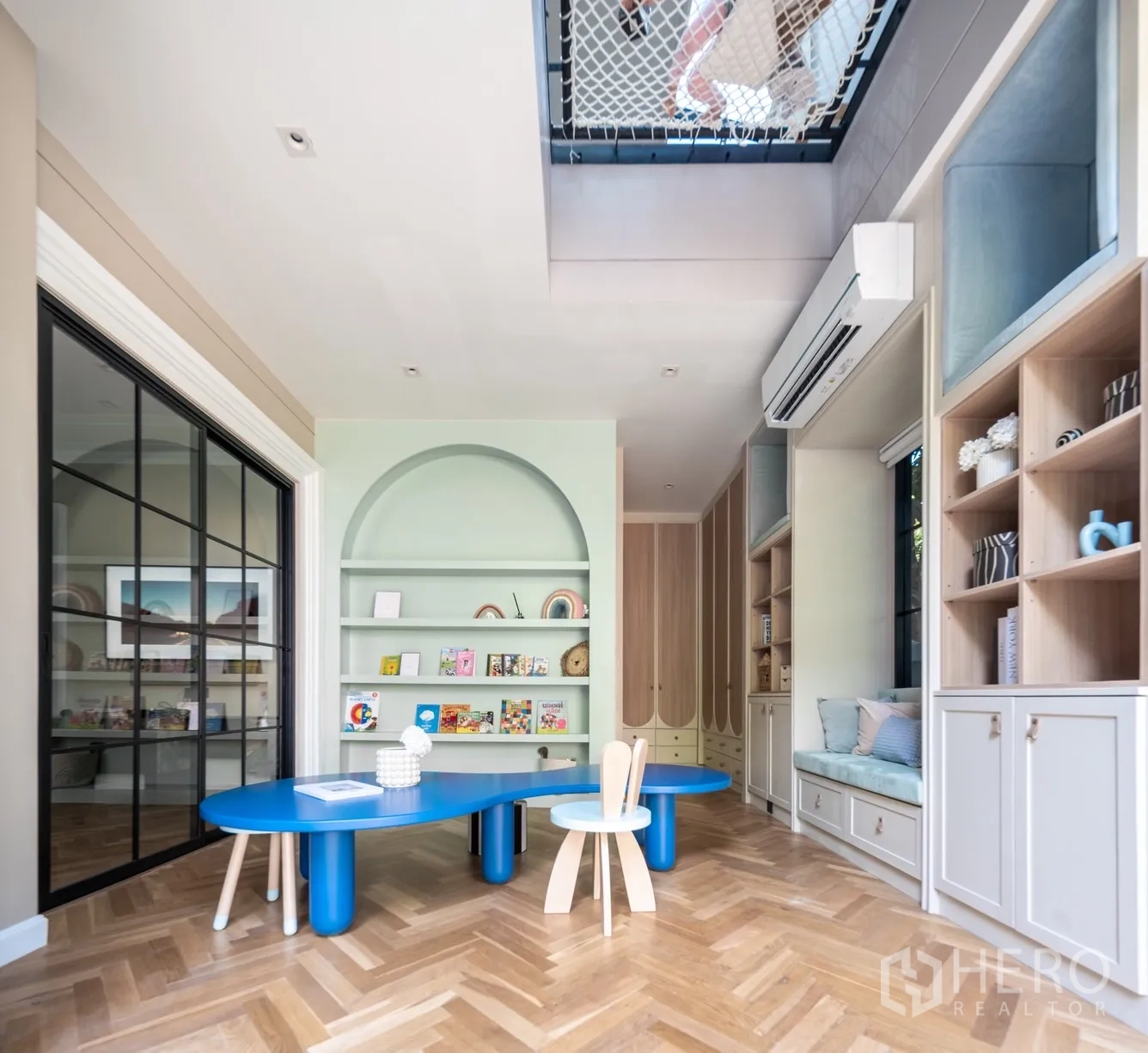 Detached House for rent or sale in Phra Khanong, Bangkok - Custom playroom with curved shelves, blue worktable and a skylight net above.