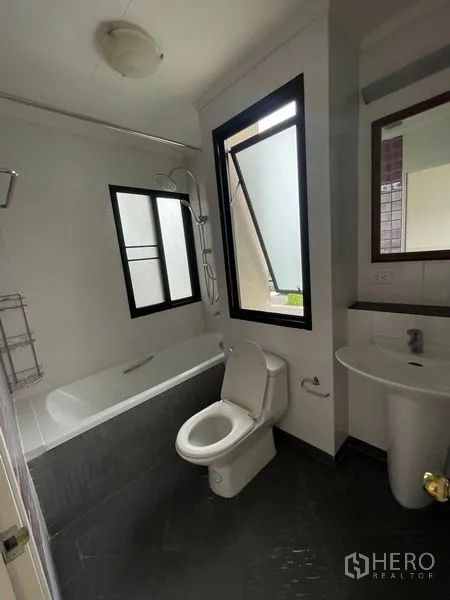 Condominium for rent in Watthana, Bangkok - Bathroom with bathtub, window ventilation and handheld shower.