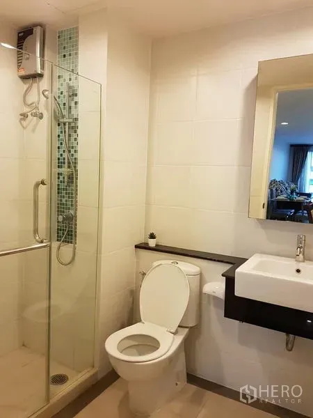 Condominium for rent in Phaya Thai, Bangkok - Modern bathroom with a glass shower enclosure, mosaic tile accent and wall-mounted water heater.