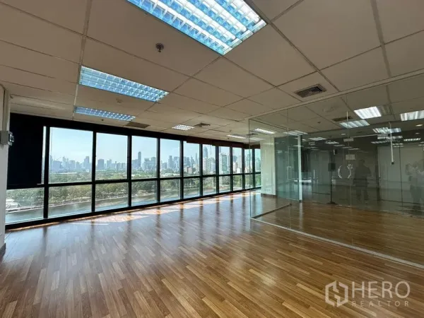 Office Space for rent in Watthana, Bangkok - Open office with a glass meeting room and wide windows framing Bangkok skyline views.