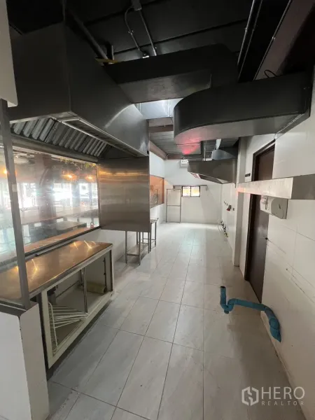 Retail Space for rent in Watthana, Bangkok - Back-of-house kitchen with tiled floor, stainless prep counters and large extraction ducting.