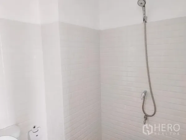 Townhouse for rent in Chatuchak, Bangkok - White tiled shower area with handheld shower and hose.