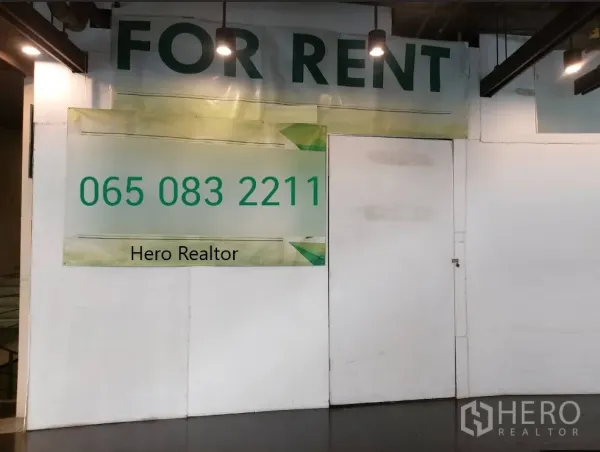 Retail Space for rent in Khlong Toei, Bangkok - For rent banner on a hoarded retail unit under ceiling spotlights inside the mall.