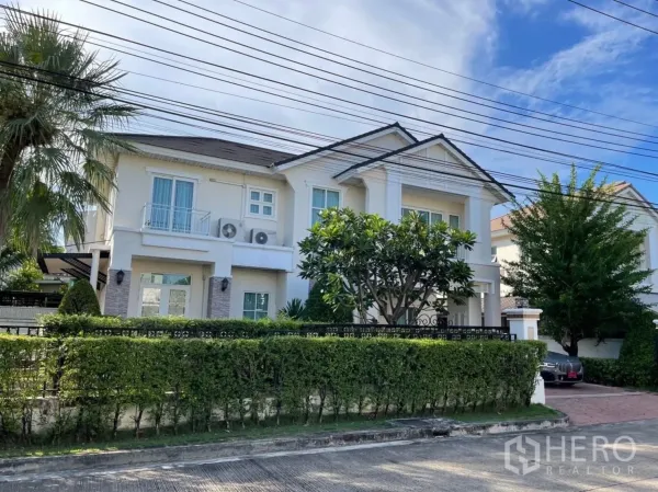 บ้าน ให้เช่าในPrawet, Bangkok - ด้านหน้าบ้านเดี่ยวสองชั้น เขตประเวศ กรุงเทพฯ พร้อมรั้วพุ่มไม้และทางรถเข้า