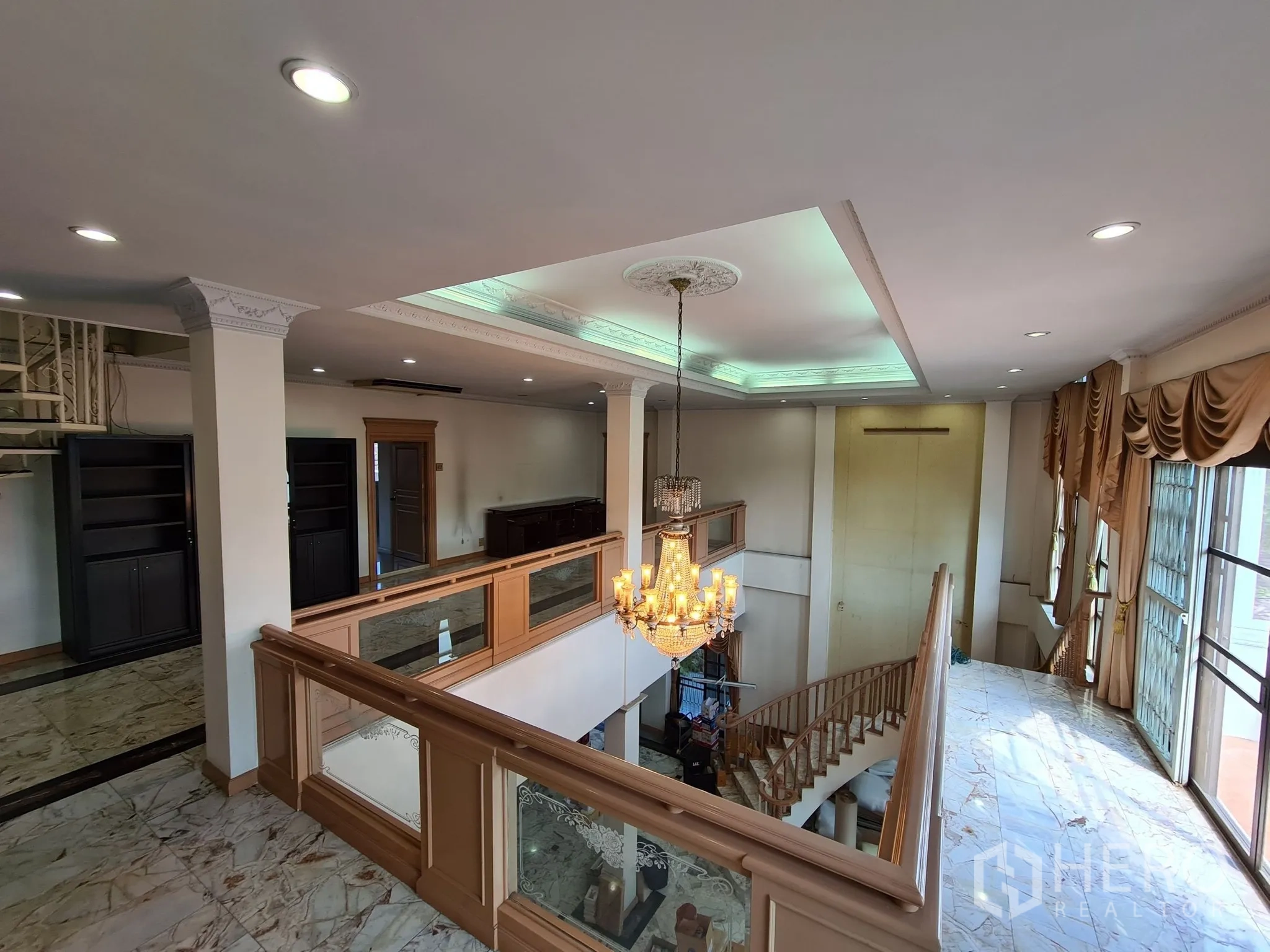 Detached House for sale in Chatuchak, Bangkok - Chandelier over gallery overlooking the grand foyer and tall windows.