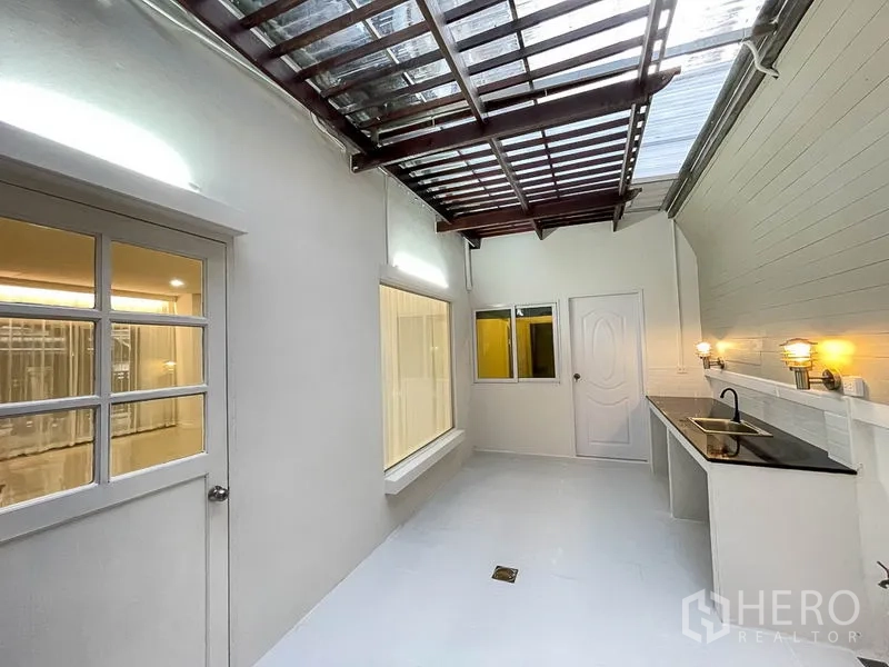 Townhouse for rent in Yan Nawa, Bangkok - Covered rear utility area with skylight roof, sink and counter for laundry or Thai kitchen.