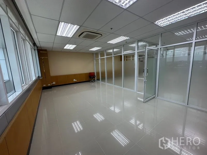 Office Space for rent in Suan Luang, Bangkok - Long windowed workspace with cassette AC and adjoining glass-partitioned meeting rooms.