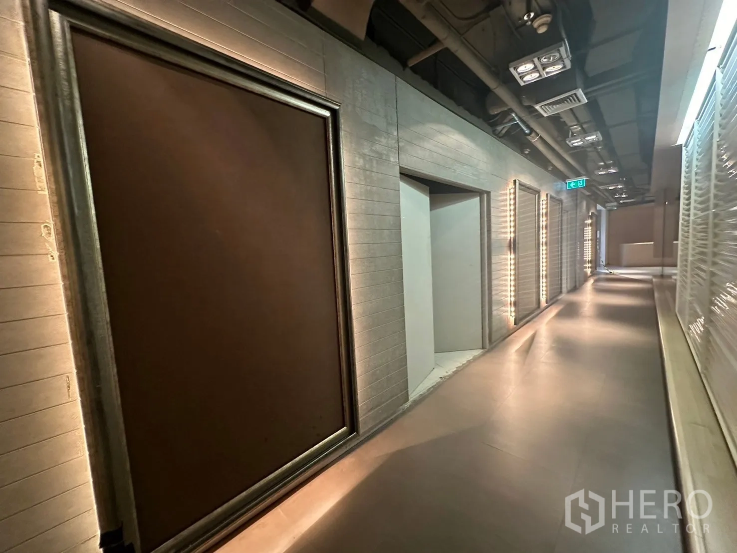 Office Space for rent in Khlong Toei, Bangkok - Ambient hallway with light strips and doorways to service rooms.