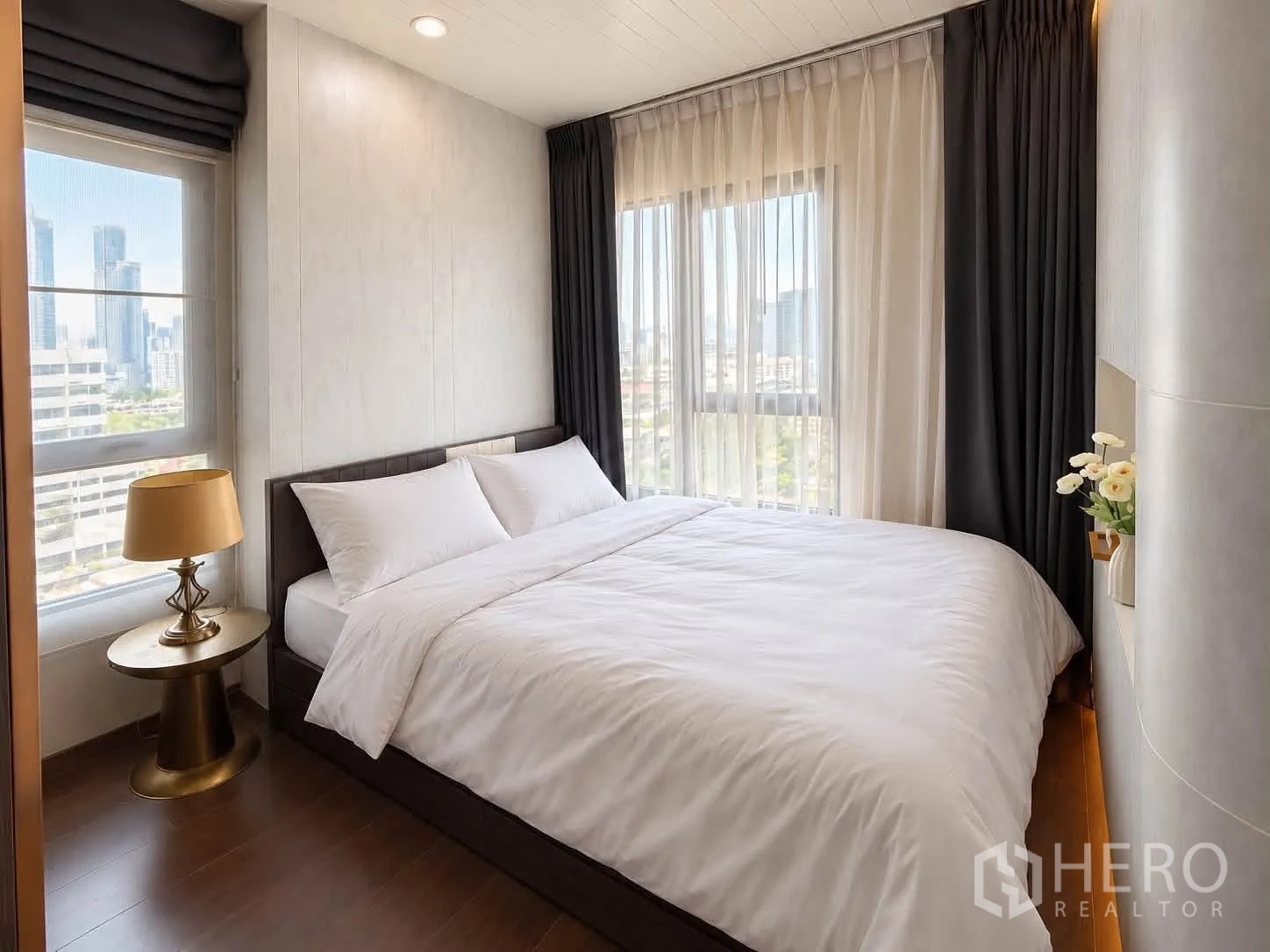 Condominium for rent in Watthana, Bangkok - Second bedroom with double bed, side table lamp, and city views.