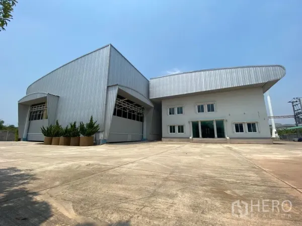 Factory for rent or sale in Samut Sakhon - Front facade of modern factory and office block with ample parking and loading yard.