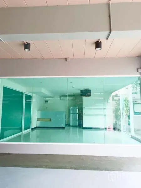 Retail Space for rent - Street-level retail unit with floor-to-ceiling glass frontage and bright tiled interior.