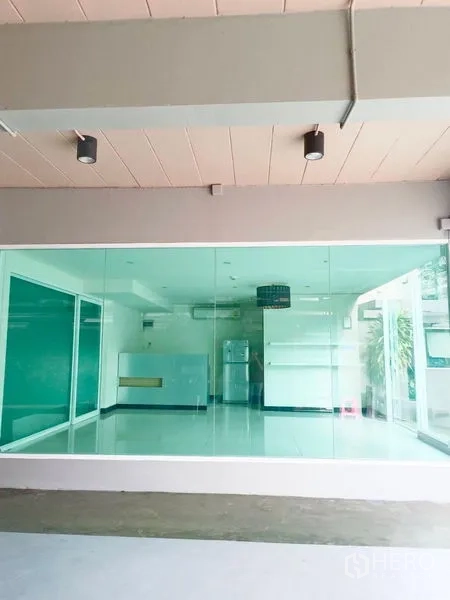 Retail Space for rent - Street-level retail unit with floor-to-ceiling glass frontage and bright tiled interior.