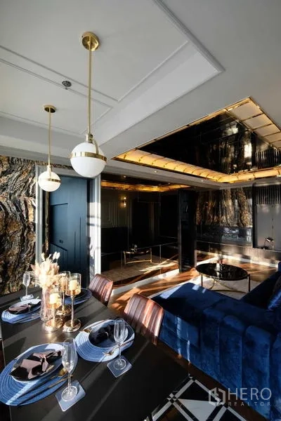 Condominium for sale - Open-plan dining and lounge with blue sofa and striking stone accent wall.