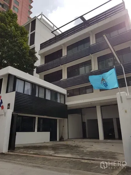 Home Office for sale in Khlong Toei, Bangkok - Front elevation of the home office with driveway and multi-level balconies.
