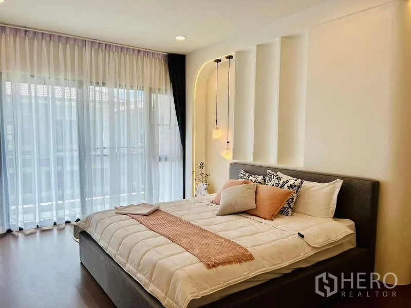 Detached House for rent in Bang Phli, Samut Prakan - Bedroom with floor-to-ceiling sheer curtains and a view toward the balcony.