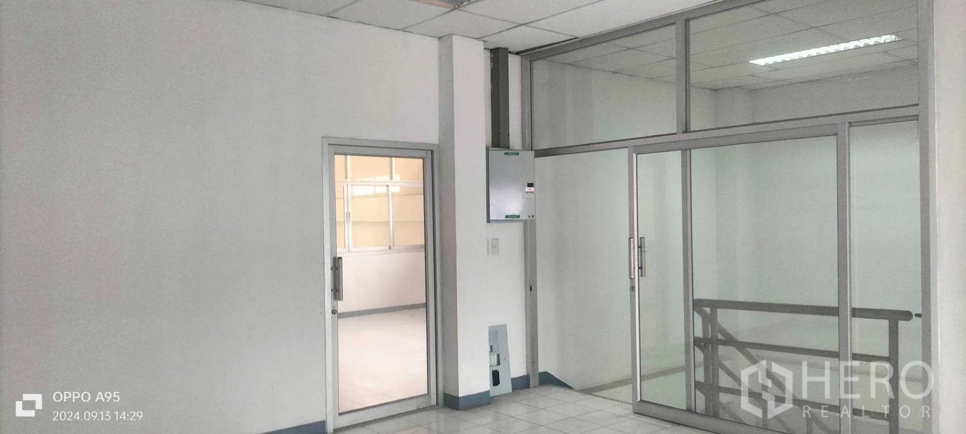 Factory for rent in Khlong Luang, Pathum Thani - Office landing with glass partitions and an electrical panel.
