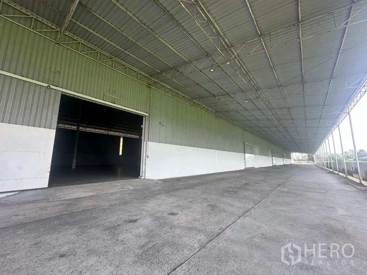 Warehouse for rent in Bang Pa-in, Phra Nakhon Si Ayutthaya - Loading canopy with open shutter doorway leading into the warehouse.