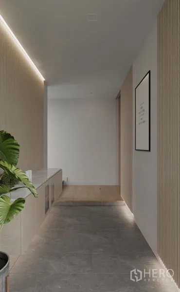 Detached House for rent in Saphan Sung, Bangkok - Minimal corridor with cove lighting, stone floor and potted plant.