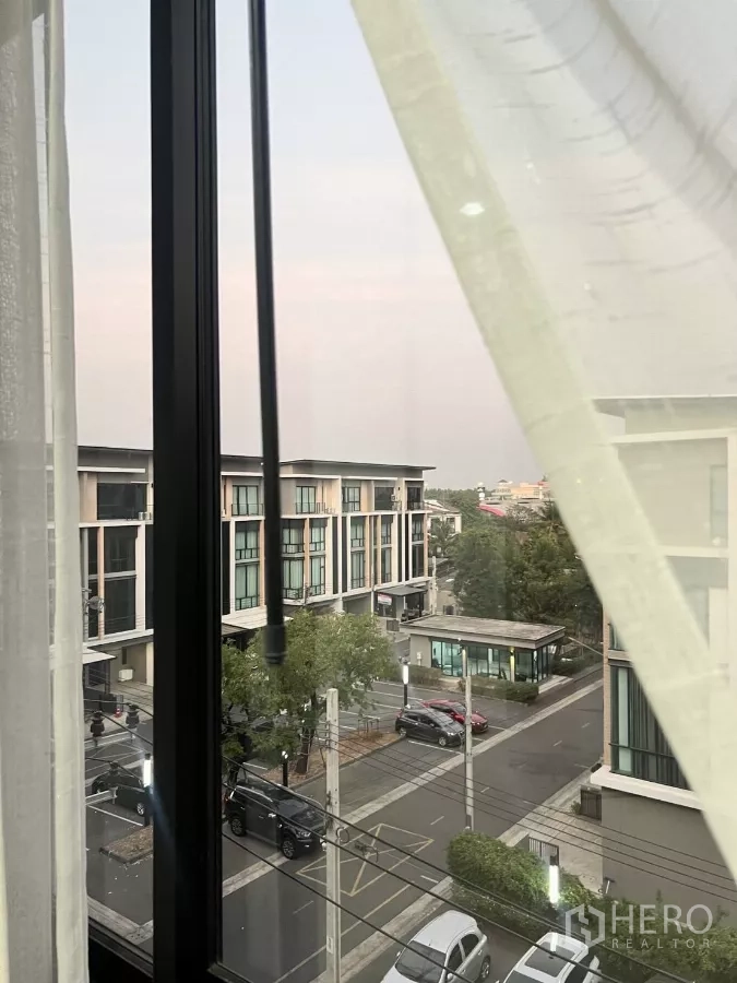 Home Office for rent in Lat Phrao, Bangkok - View from an upper-floor window across the gated community street and home office blocks.