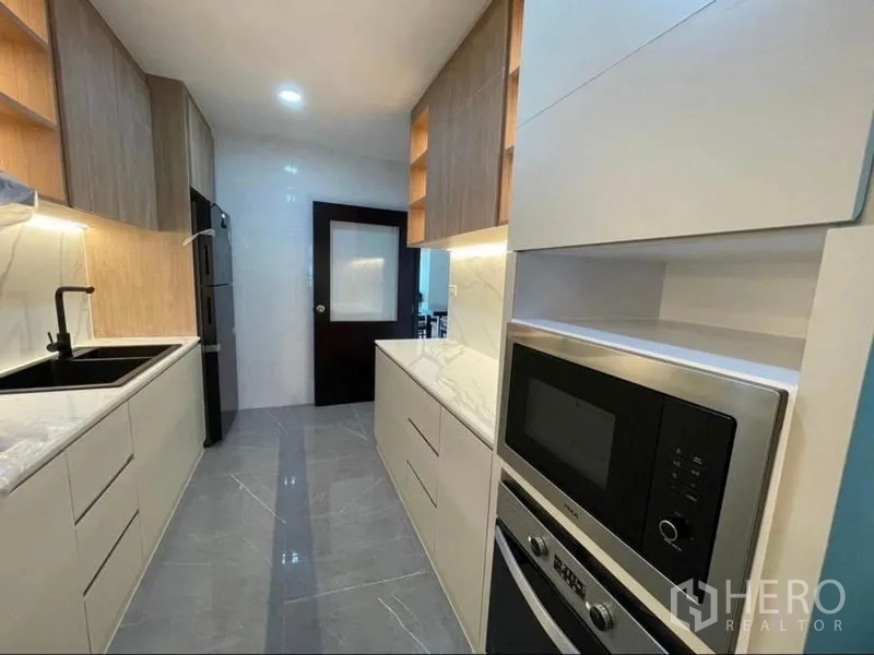 Condominium for rent - Full view of galley kitchen with built-in oven and ample cabinetry.