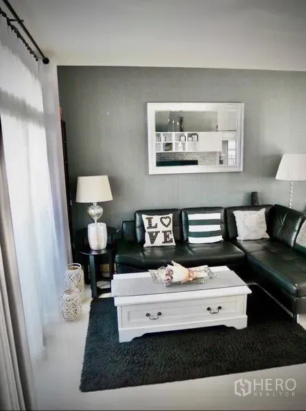 Detached House for rent or sale in Bang Phli, Samut Prakan - Cozy living room with black leather sectional, white coffee table and large window