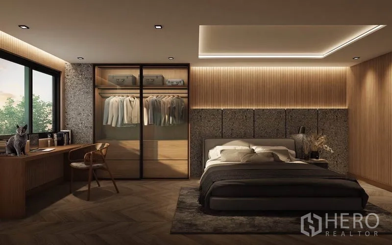 Detached House for rent in Watthana, Bangkok - Master bedroom with warm wood paneling, glass-door wardrobe, and a desk by the window.