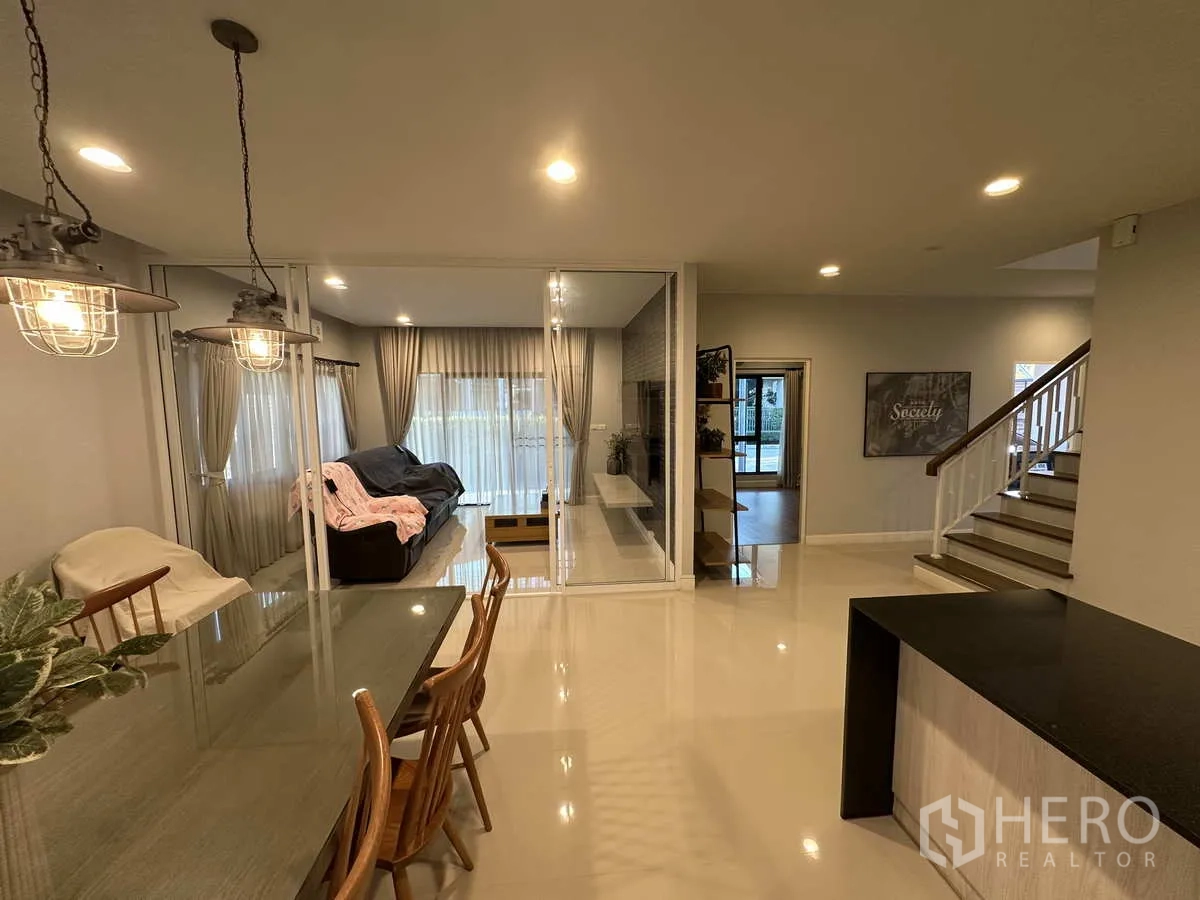 Detached House for rent or sale in Lam Luk Ka, Pathum Thani - View from dining to staircase and glass partitions with large windows.