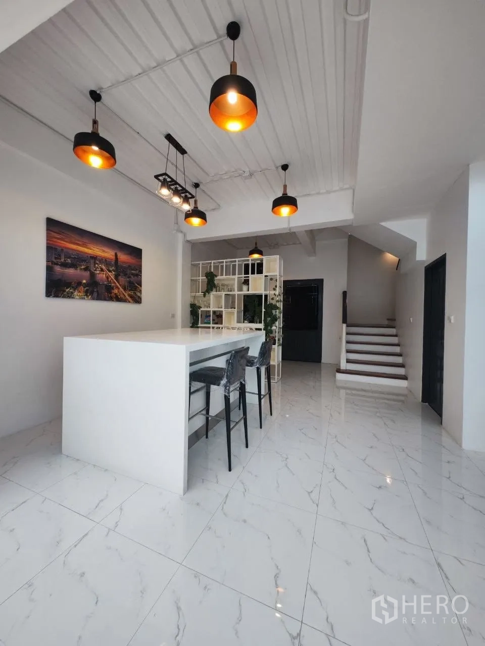 Home Office for rent in Bang Na, Bangkok - Open-plan area with long island counter, pendant lights and staircase.