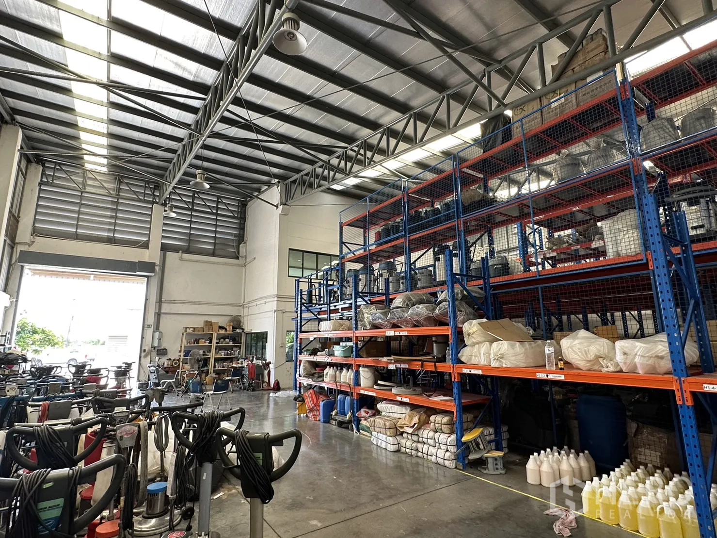 Factory for rent or sale in Pathum Thani - Warehouse interior with high clear ceiling, skylights and heavy-duty storage racks.