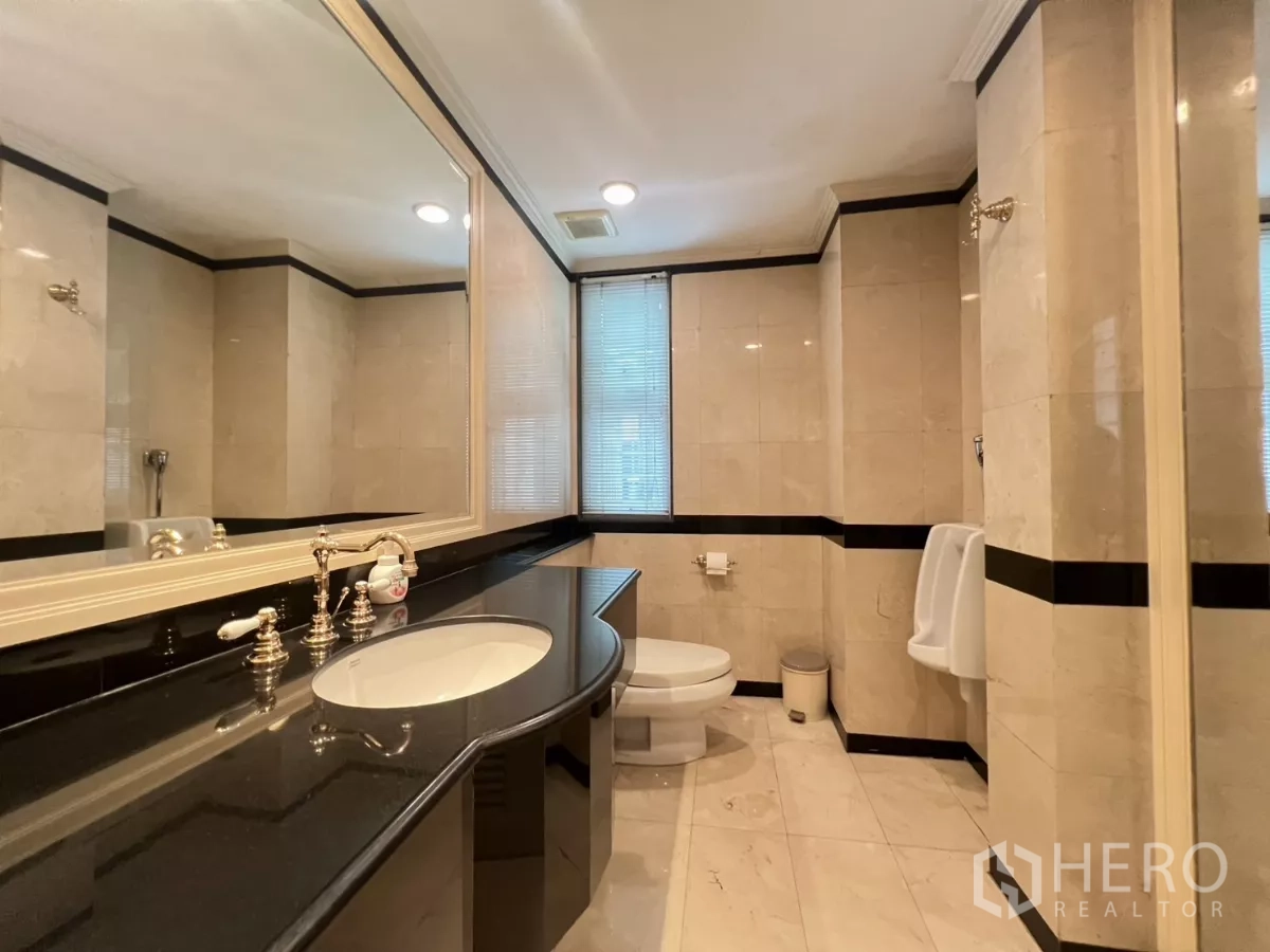 Townhouse for sale in Watthana, Bangkok - Tiled bathroom with long vanity, large mirror and sanitary fixtures.
