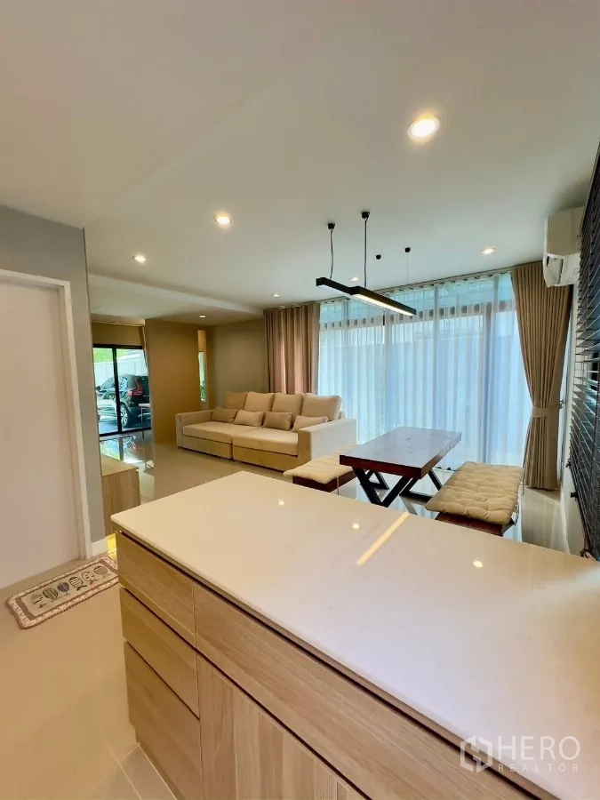 Detached House for rent in Samut Prakan - View from kitchen island toward living room and sliding glass doors.