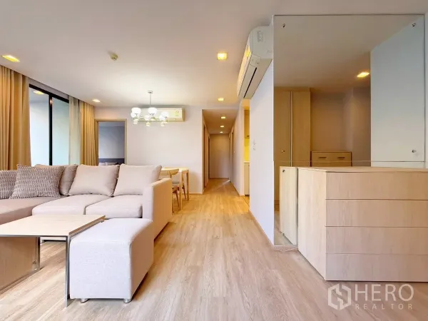 公寓 出租或出售在Watthana, Bangkok - 客厅带镜面墙、木地板与用餐角。
