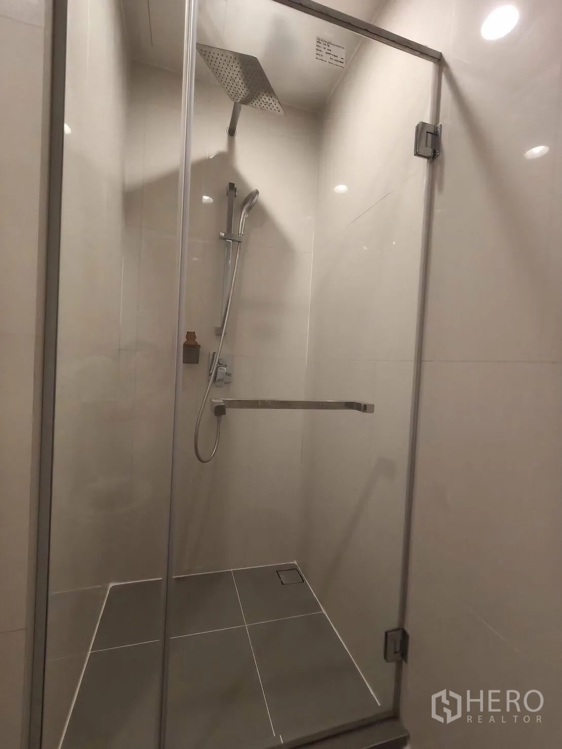 Condominium for rent in Khlong Toei, Bangkok - Glass-enclosed shower with a rain showerhead and handheld sprayer.