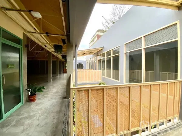 Retail Space for rent in Watthana, Bangkok - Bright covered corridor with perforated railings and floor-to-ceiling windows.