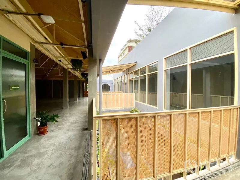 Retail Space for rent in Watthana, Bangkok - Bright covered corridor with perforated railings and floor-to-ceiling windows.