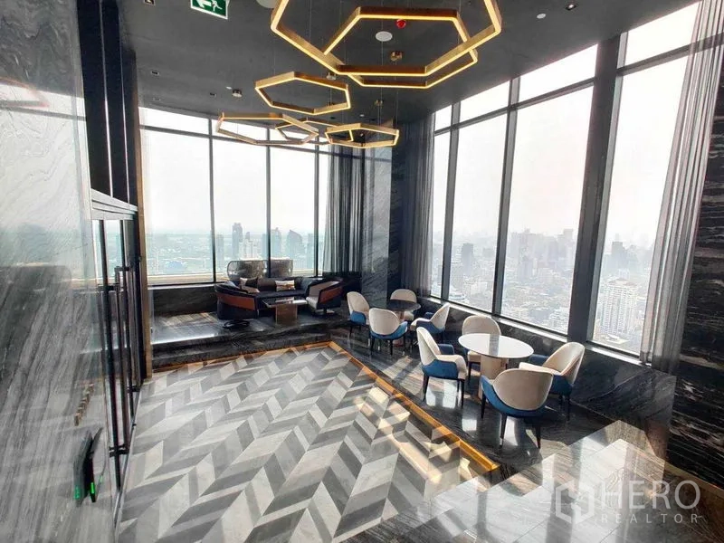 Condominium for rent in Watthana, Bangkok - Lounge area with hexagon chandeliers and city-view seating.