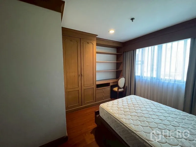 Condominium for rent in Watthana, Bangkok - Third bedroom with single bed, air conditioning, and curtained window.