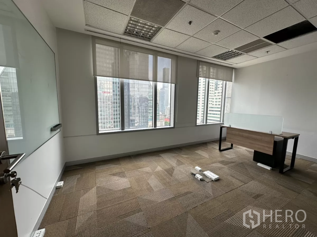 Office Space for rent in Watthana, Bangkok - Private office with roller blinds, single desk and city views from large windows.