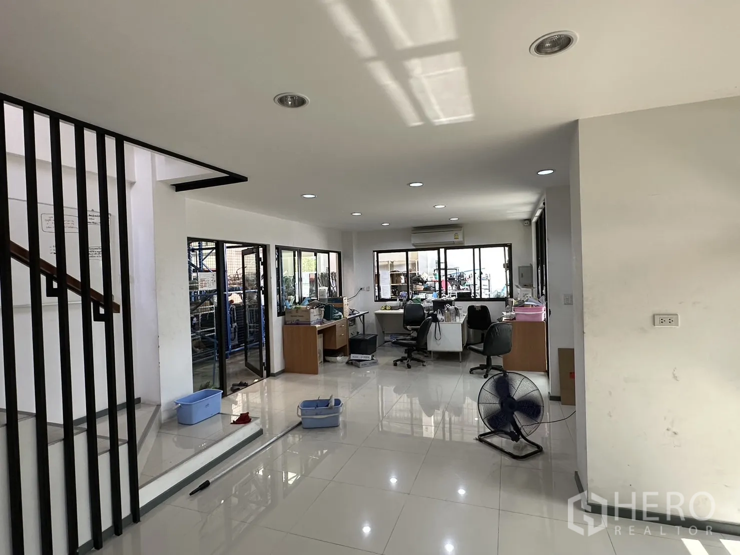 Factory for rent or sale in Pathum Thani - Ground-floor office area with glass partitions overlooking the warehouse.