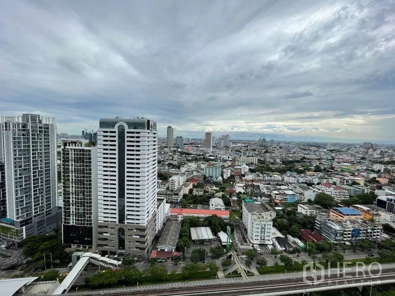 Condominium for sale - High-floor panoramic view of the Sathon skyline and rail line from the balcony.